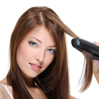 girl doing hairstyle with flat iron